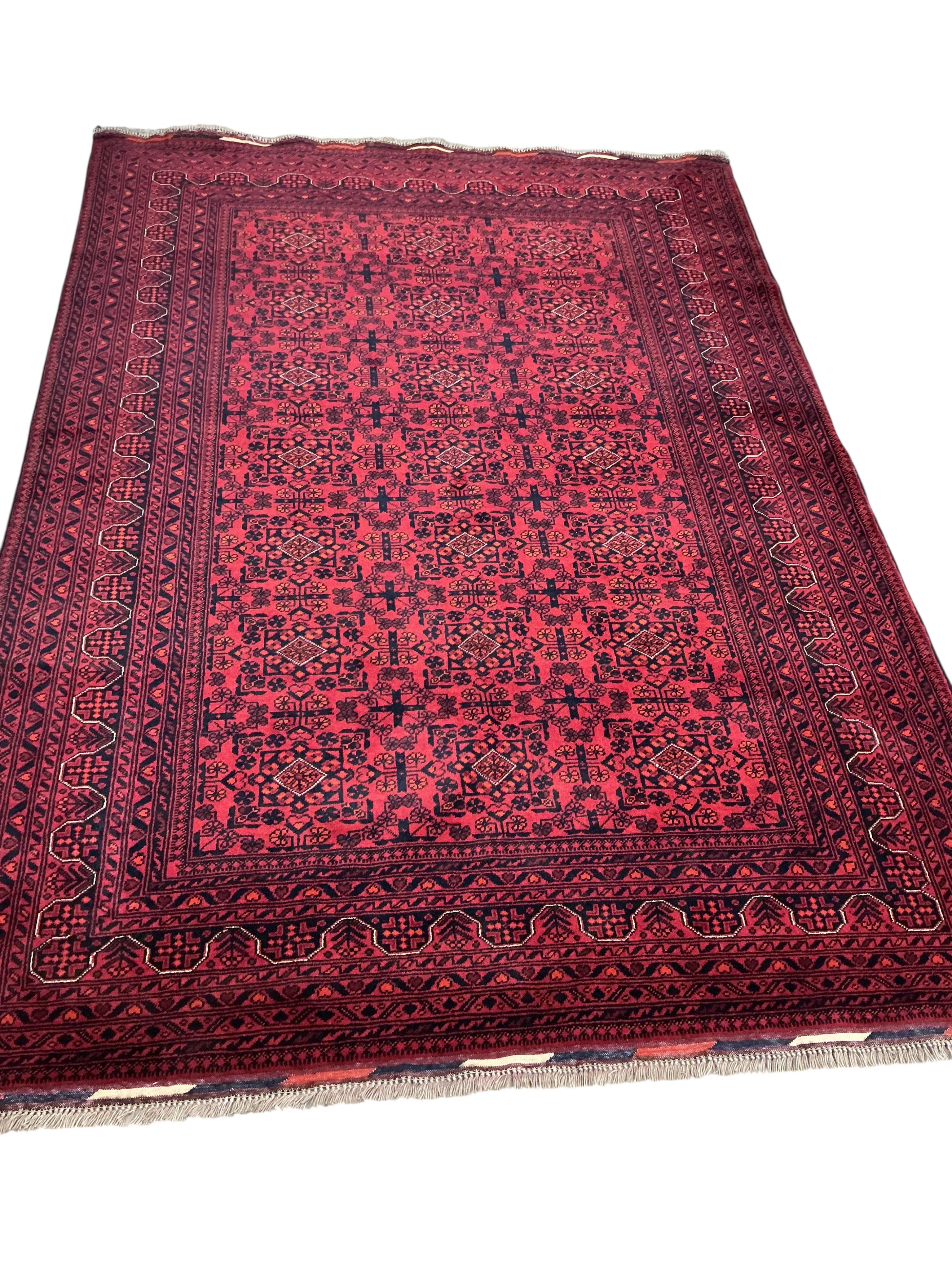 A Belouch red ground carpet, 240 x 170cm